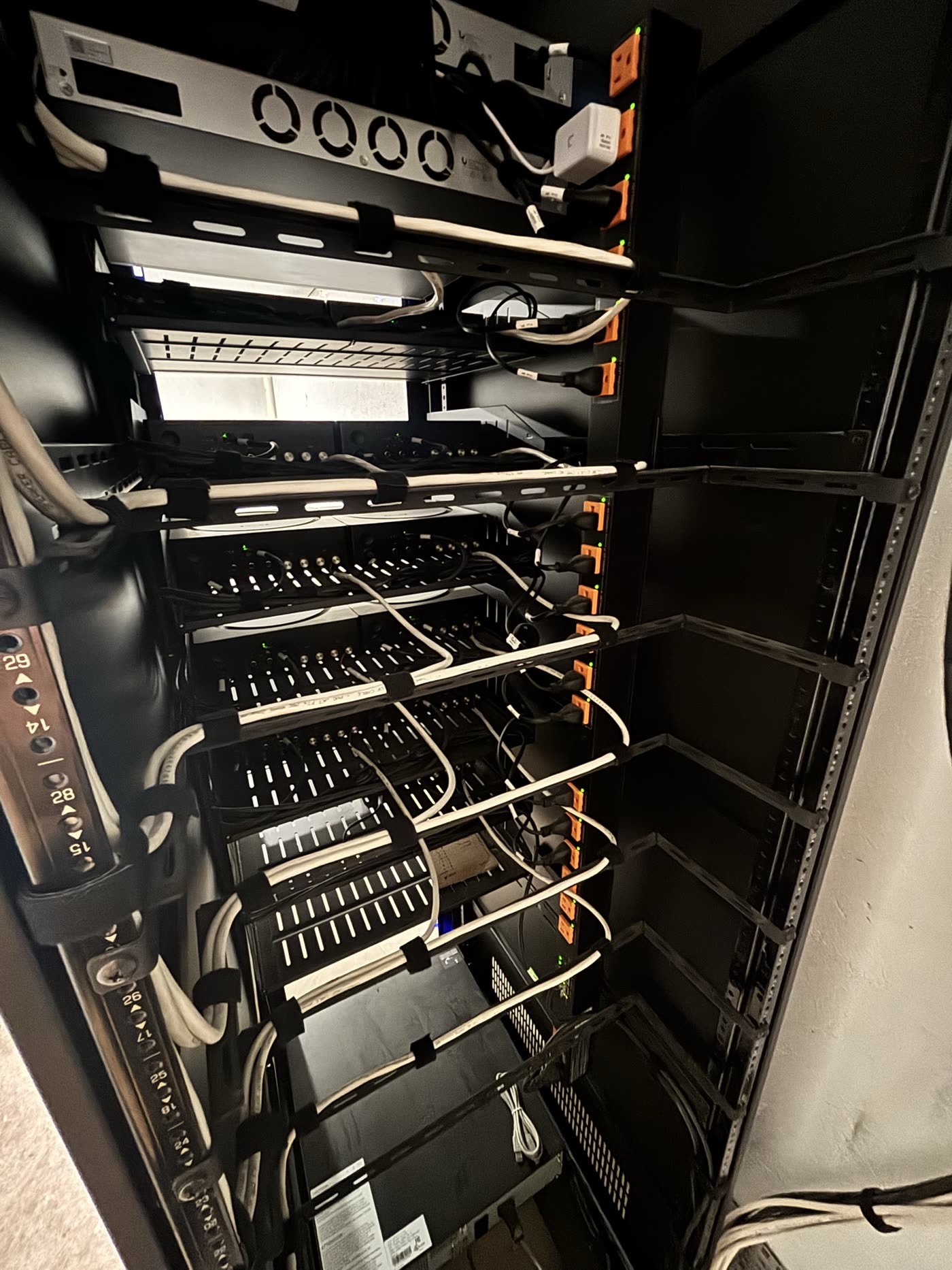 Restrepo Innovations branded Strong rack installed at 50 Summit medical office, with cable management and labeled patch panels