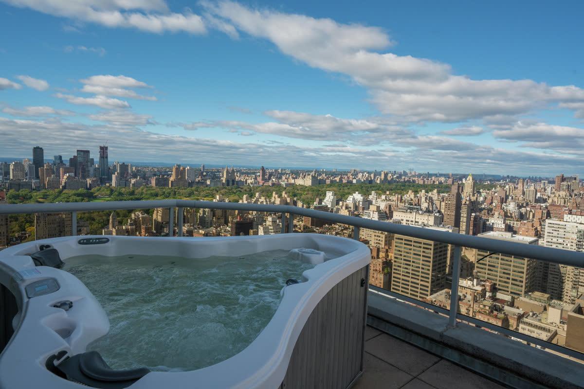 Audio Command Systems outdoor living project with a rooftop spa and New York skyline view