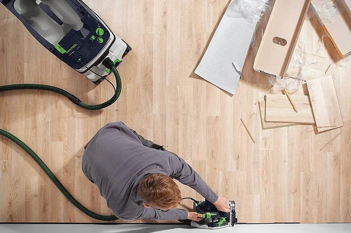 Homework Renovation craftsperson using a Festool track saw while fitting flooring on a residential job site