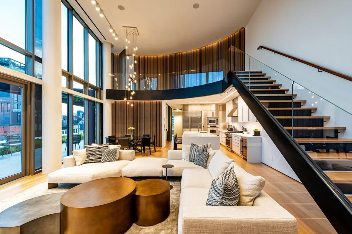 Homework Renovation finished New York living room with full-height windows, staircase, and integrated media wall