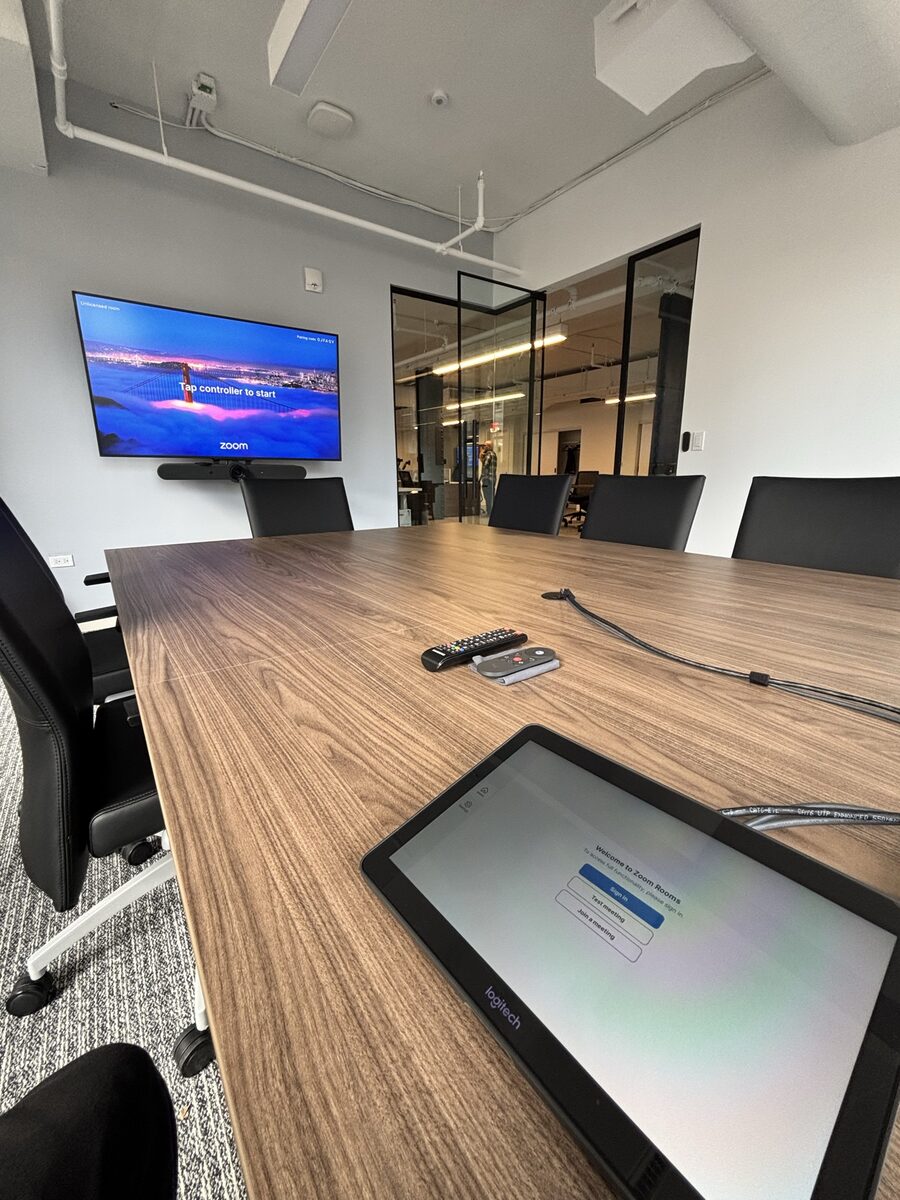 Logitech Tap touch controller on the conference table ready to start a Zoom Rooms meeting