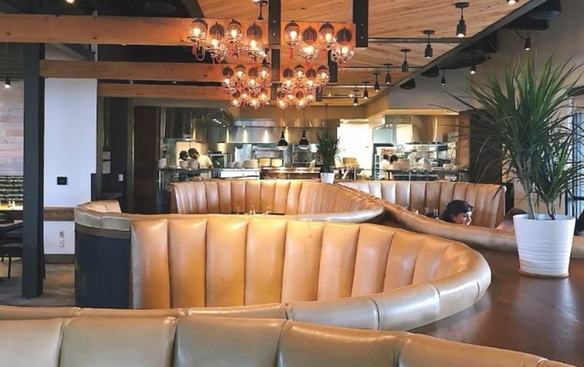Exposed-ceiling restaurant dining room, the type of commercial space where SoundTube open-ceiling pendant speakers are typically installed