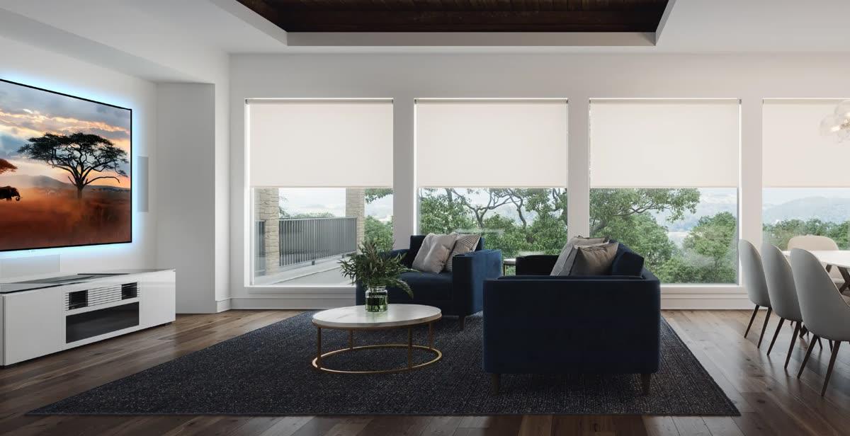 Screen Innovations motorized shades and projection screen in a bright living room with controlled daylight