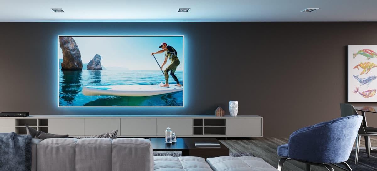 Screen Innovations Zero Edge projection screen in a modern living room with motorized window shades
