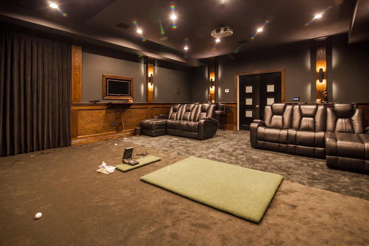 Sinclair Homes custom home builder project with a dedicated theater, dark acoustic walls, and leather seating