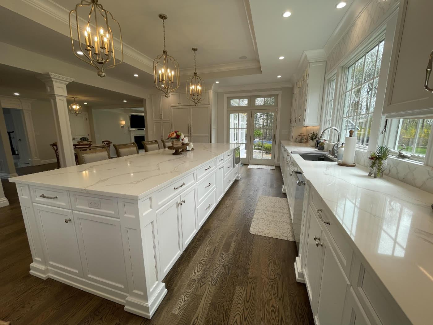 Prominent Builders recent kitchen renovation with waterfall island and pendant lighting
