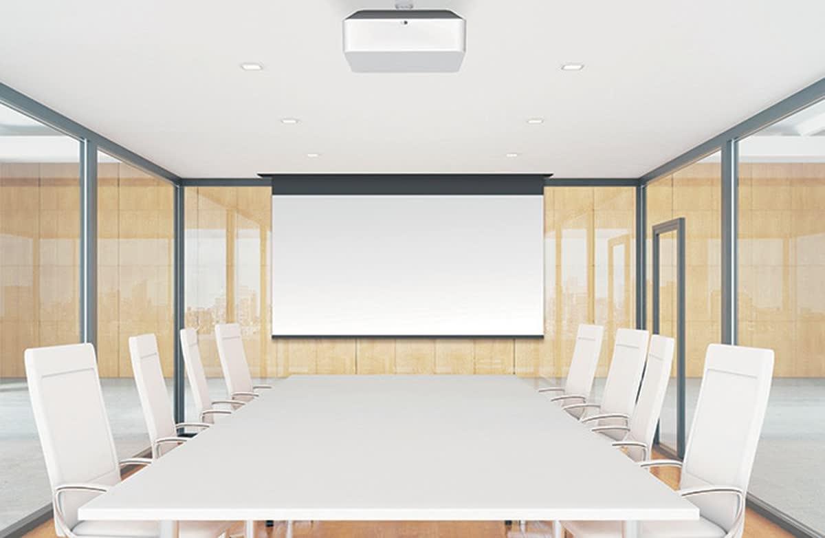 Sony laser projector ceiling-mounted in a minimalist corporate conference room